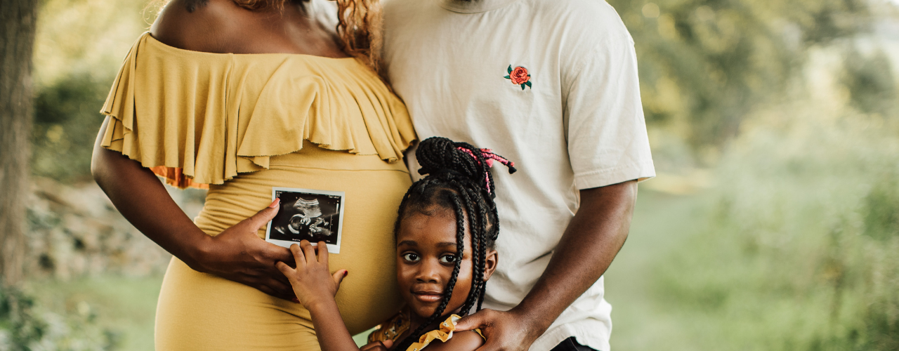 two adults, a young girl, an an ultrasound photo