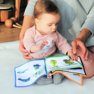 adult reading to baby